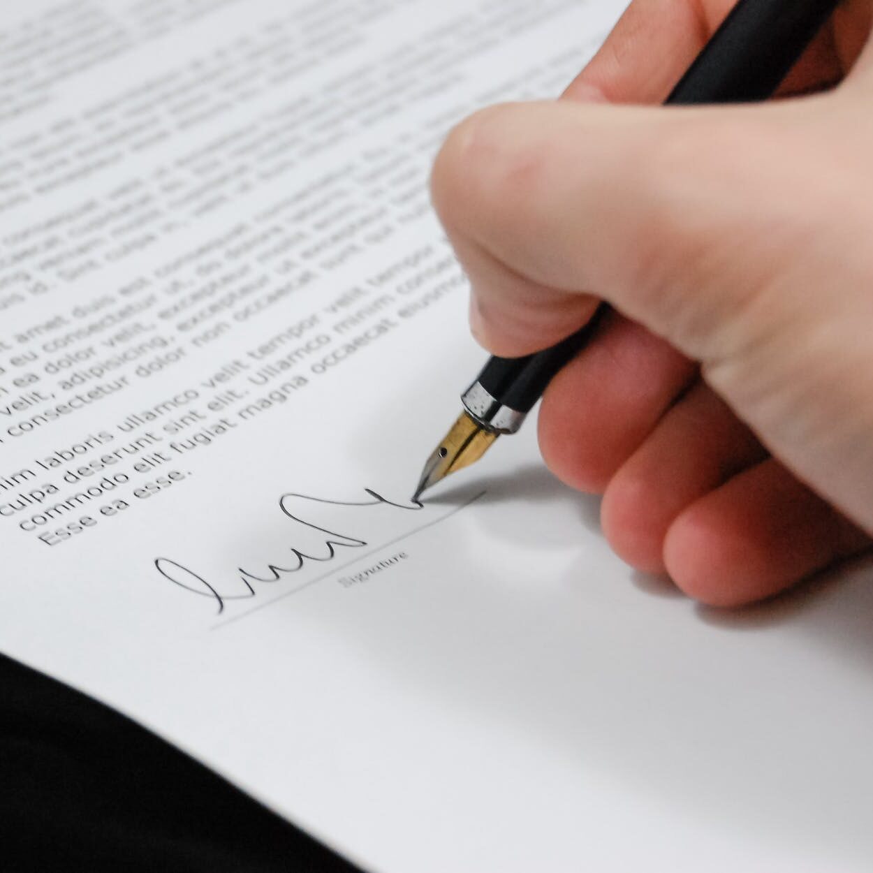 person signing in documentation paper