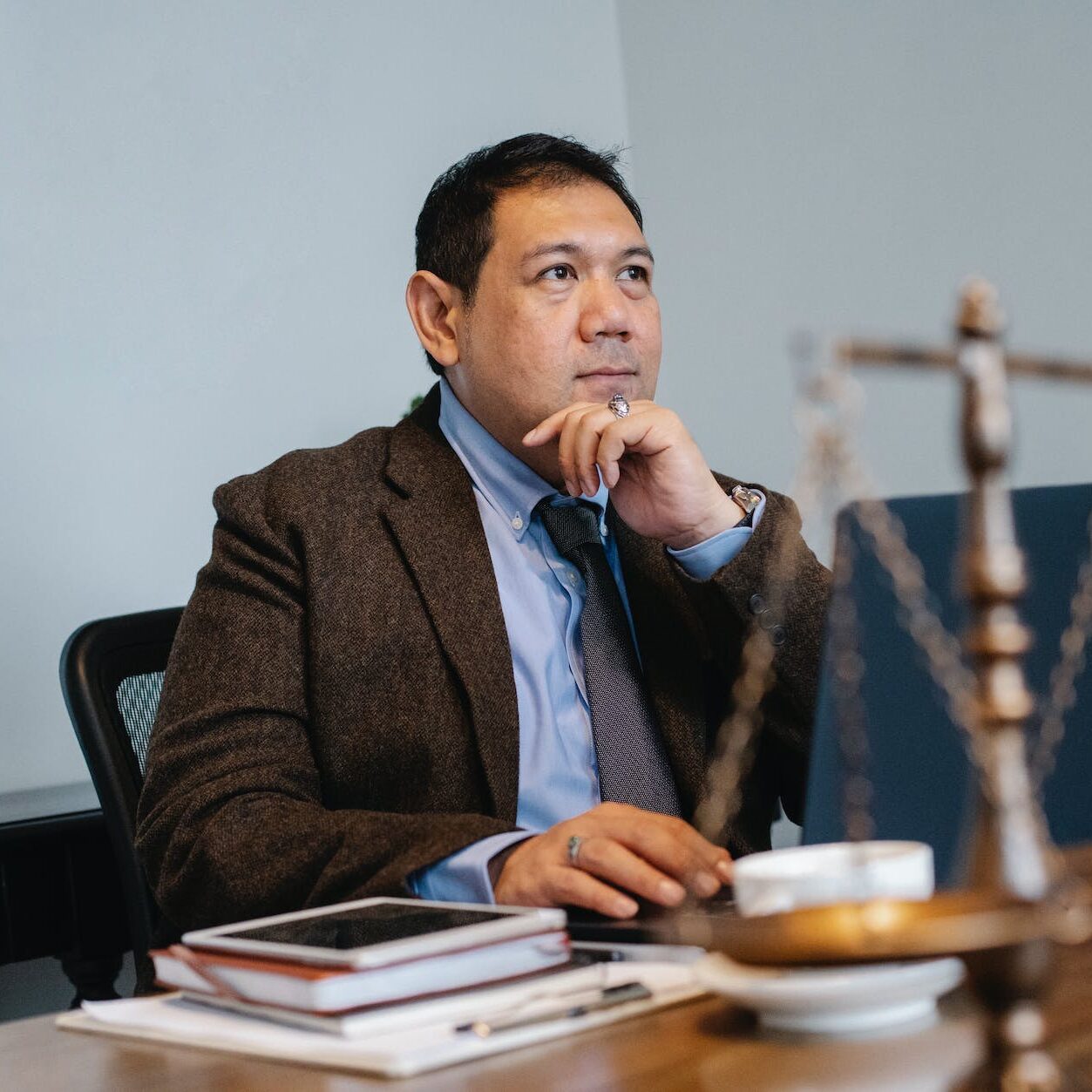 asian male judge working on laptop in office